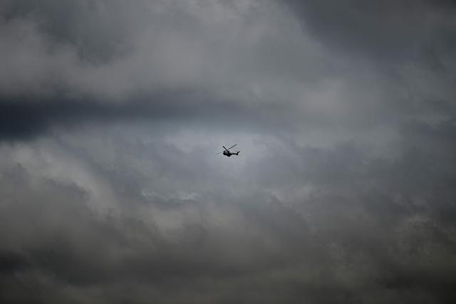 A Venezuelan army helicopter flies over Las Brisas de Cuyuni, as seen from an artisanal gold mine near the town of Las Claritas in Bolivar state, Venezuela, during a security operation on June 11, 2026. Venezuela, home to the world's largest oil reserves, also has deposits of gold, diamonds, bauxite, coltan and rare earths, but much of its mining areas — notably the 112,000 sq km Mining Arc located in remote regions far from major cities — is controlled by armed gangs or guerrilla groups. (Photo by Federico PARRA / AFP)