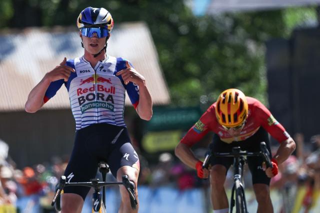 Red Bull - Bora - Hansgrohe's Belgian rider Maxim Van Gils celebrates as he cycles across the finish line to win ahead of Uno-X Mobility's Norwegian rider Tobias Johannessen (R) during the 6th stage of the Tour Auvergne-Rhone-Alpes cycling race (formerly known as the Criterium du Dauphine), 182,3km between Saint-Vulbas and Crest-Voland in the French Alps on June 12, 2026. (Photo by Anne-Christine POUJOULAT / AFP)