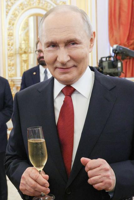 In this pool photograph distributed by the Russian state agency Sputnik, Russia's President Vladimir Putin holds a glass for a toast following the ceremony for the presentation of the 2025 State Prizes in Science and Technology, Literature and the Arts, and for Outstanding Achievements in Human Rights, Humanitarian, and Charitable Activities, as well as the awarding of the Gold Medals of Hero of Labour of the Russian Federation in Moscow on June 12, 2026. (Photo by Viacheslav PROKOFIEV / POOL / AFP)