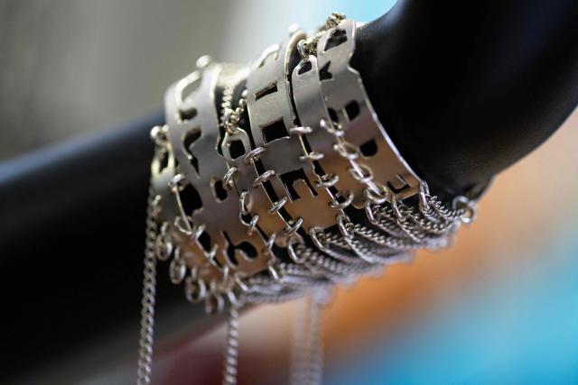 This photograph shows a creation by recycled jewellery designer and founder of Capobianco, Juliette Moutte, made in Marseille in her workshop and shop, in the Camas neighbourhood of Marseille, on June 9, 2026. In Marseille, Slow Fashion Week is making its rebellious, popular, and sustainable mark on the fashion world: free and colourful fashion shows, open to all, featuring collections where secondhand textiles reign supreme. (Photo by MIGUEL MEDINA / AFP)