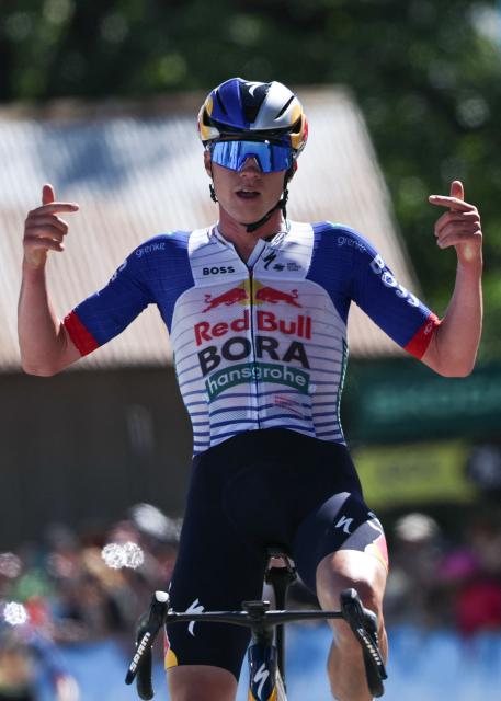 Red Bull - Bora - Hansgrohe's Belgian rider Maxim Van Gils celebrates as he cycles across the finish line to win the 6th stage of the Tour Auvergne-Rhone-Alpes cycling race (formerly known as the Criterium du Dauphine), 182,3km between Saint-Vulbas and Crest-Voland in the French Alps on June 12, 2026. (Photo by Anne-Christine POUJOULAT / AFP)