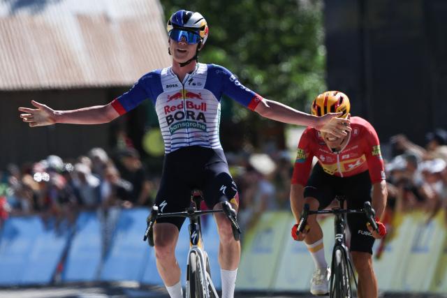Red Bull - Bora - Hansgrohe's Belgian rider Maxim Van Gils celebrates as he cycles across the finish line to win ahead of Uno-X Mobility's Norwegian rider Tobias Johannessen (R) during the 6th stage of the Tour Auvergne-Rhone-Alpes cycling race (formerly known as the Criterium du Dauphine), 182,3km between Saint-Vulbas and Crest-Voland in the French Alps on June 12, 2026. (Photo by Anne-Christine POUJOULAT / AFP)