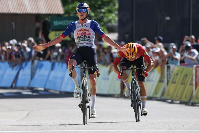 Red Bull - Bora - Hansgrohe's Belgian rider Maxim Van Gils celebrates as he cycles across the finish line to win ahead of Uno-X Mobility's Norwegian rider Tobias Johannessen (R) during the 6th stage of the Tour Auvergne-Rhone-Alpes cycling race (formerly known as the Criterium du Dauphine), 182,3km between Saint-Vulbas and Crest-Voland in the French Alps on June 12, 2026. (Photo by Anne-Christine POUJOULAT / AFP)