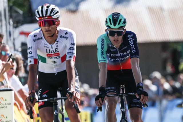 UAE Team Emirates XRG's Mexican rider Isaac Del Toro Romero (L) and Decathlon CMA CGM Team's French rider Paul Seixas (R) cycles across the finish line of the 6th stage of the Tour Auvergne-Rhone-Alpes cycling race (formerly known as the Criterium du Dauphine), 182,3km between Saint-Vulbas and Crest-Voland in the French Alps on June 12, 2026. (Photo by Anne-Christine POUJOULAT / AFP)