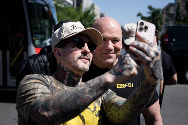 Dana White (R), President and CEO of Ultimate Fighting Championship (UFC), poses for a picture with a fan a few blocks away from the White House in Washington, DC on June 12, 2026. The UFC Freedom 250 event will be held on the South Lawn of the White House on US President Donald Trump's 80th birthday on June 14. (Photo by Brendan Smialowski / AFP)