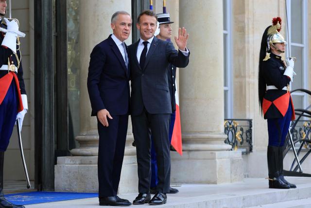 France's President Emmanuel Macron (CR) poses with Canadian Prime Minister Mark Carney (CL) as he welcomes him to The Elysee Presidential Palace ahead of a bilateral meeting, in Paris on June 12, 2026. (Photo by Ludovic MARIN / AFP)