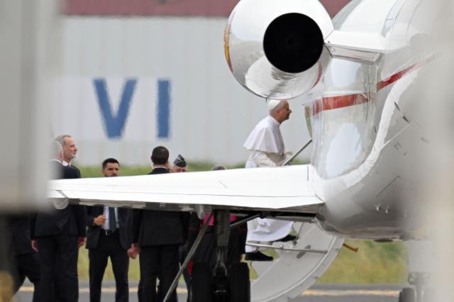 Pope Leo XIV embarks a new aircraft offered by Spanish King Felipe VI (L) after his first plane's takeoff was delayed due to an incident at Los Rodeos International Airport on the Canary Island of Tenerife on June 12, 2026. Pope Leo XIV will return to Rome from the Canary Islands today on a plane offered by Spanish King Felipe VI after his orginal aircraft suffered a technical glitch, the Vatican said. The flight is scheduled to depart Tenerife at 6 pm (1700 GMT) and arrive in Rome at around 11 pm, it said in a statement. (Photo by JORGE GUERRERO / AFP)