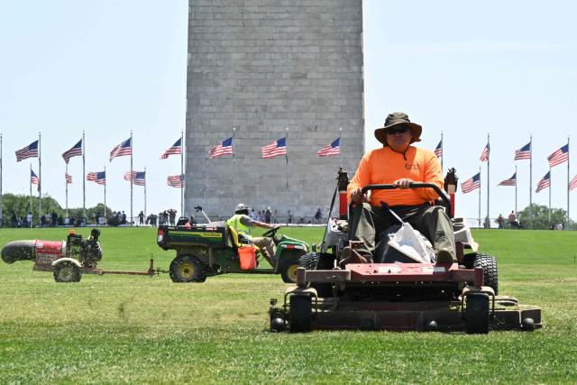 Workers mow grass near the area where the numbers "8647" appeared on the lawn on the National Mall in Washington, DC, on June 12, 2026. US Park Police opened an investigation on June 11 into giant markings of the numbers "8647" -- which have been associated with opposition to President Donald Trump -- on the grass of the National Mall. A spokesperson for the Department of the Interior, which manages the National Mall in downtown Washington, described the incident as "deranged vandalism" and said it "will not be tolerated." (Photo by Anne Lebreton / AFP)