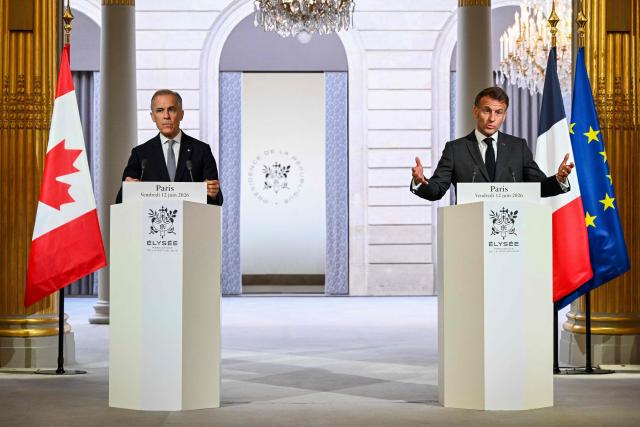 France's President Emmanuel Macron (R) gestures as he addresses the media during a press conference with Canada's Prime Minister Mark Carney (L) ahead of a bilateral meeting at the Elysee Presidential Palace, in Paris on June 12, 2026. (Photo by POOL / AFP)