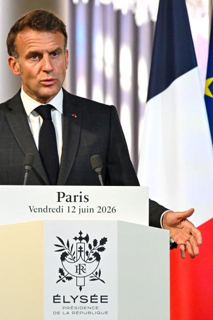 France's President Emmanuel Macron gestures as he addresses the media during a press conference with Canada's Prime Minister Mark Carney (not pictured) ahead of a bilateral meeting at The Elysee Presidential Palace, in Paris on June 12, 2026. (Photo by POOL / AFP)