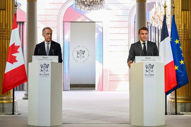 France's President Emmanuel Macron (R) addresses the media during a press conference with Canada's Prime Minister Mark Carney (L) ahead of a bilateral meeting at the Elysee Presidential Palace, in Paris on June 12, 2026. (Photo by POOL / AFP)