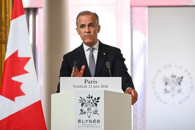 Canada's Prime Minister Mark Carney gestures as he addresses the media during a press conference with France's President Emmanuel Macron (not photographed) ahead of a bilateral meeting at the Elysee Presidential Palace, in Paris on June 12, 2026. (Photo by POOL / AFP)