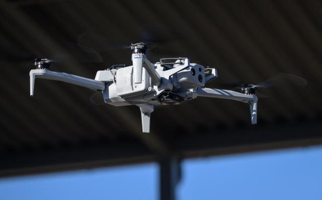 Skydio CEO Adam Bry demonstrates the Skydio X10 drone to US Trade Representative Jamieson Greer as Greer tours the SkyDio drone manufacturing facility in Hayward, California, on June 12, 2026. (Photo by Josh Edelson / AFP)