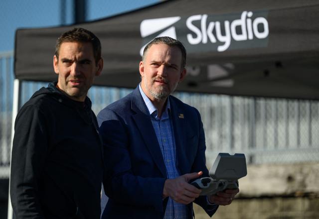 Skydio CEO Adam Bry (L) watches as US Trade Representative Jamieson Greer (R) controls a Skydio X10 drone as Greer tours the SkyDio drone manufacturing facility in Hayward, California, on June 12, 2026. (Photo by Josh Edelson / AFP)