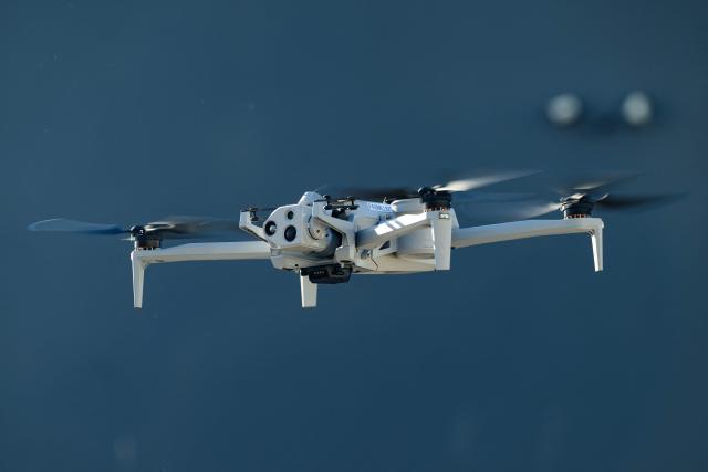 Skydio CEO Adam Bry demonstrates the Skydio X10 drone to US Trade Representative Jamieson Greer as Greer tours the SkyDio drone manufacturing facility in Hayward, California, on June 12, 2026. (Photo by Josh Edelson / AFP)