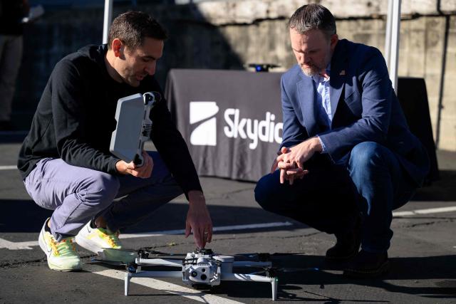 Skydio CEO Adam Bry (L) demonstrates the Skydio X10 drone to US Trade Representative Jamieson Greer (R) as Greer tours the SkyDio drone manufacturing facility in Hayward, California, on June 12, 2026. (Photo by Josh Edelson / AFP)