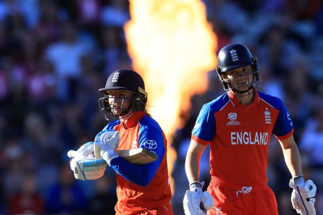 England's Danni Wyatt-Hodge (L) celebrates her half-century on the first day of the ICC Women's T20 cricket World Cup 2026 Group 2 stage cricket match between England and Sri Lanka at Edgbaston cricket ground in Birmingham, central England on June 12, 2026. (Photo by Darren Staples / AFP)