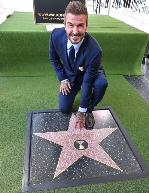 English former footballer David Beckham poses at his newly unveiled Hollywood Walk of Fame star during a ceremony in Hollywood, California, on June 12, 2026. (Photo by LISA O'CONNOR / AFP)