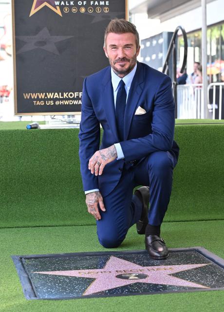 English former footballer David Beckham poses next to his newly unveiled Hollywood Walk of Fame star during a ceremony in Hollywood, California, on June 12, 2026. (Photo by LISA O'CONNOR / AFP)