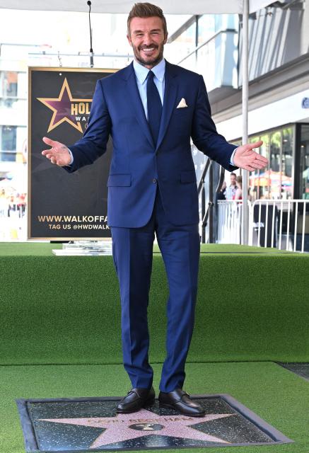 English former footballer David Beckham poses at his newly unveiled Hollywood Walk of Fame star during a ceremony in Hollywood, California, on June 12, 2026. (Photo by LISA O'CONNOR / AFP)