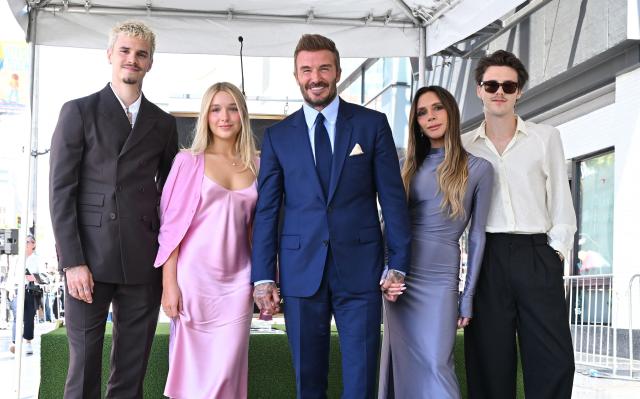 (L/R) Romeo Beckham, Harper Beckham, English former footballer David Beckham, Victoria Beckham and Cruz Beckham pose next to his newly unveiled Hollywood Walk of Fame star during a ceremony in Hollywood, California, on June 12, 2026. (Photo by LISA O'CONNOR / AFP)