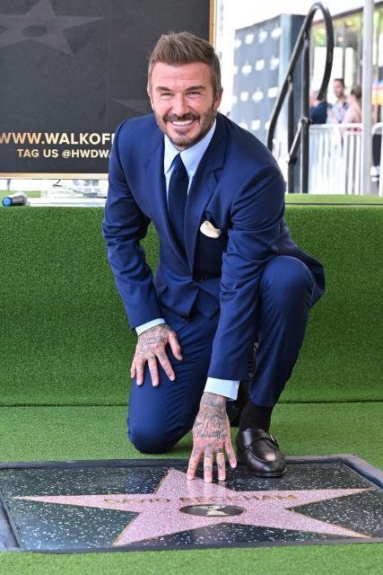 English former footballer David Beckham poses at his newly unveiled Hollywood Walk of Fame star during a ceremony in Hollywood, California, on June 12, 2026. (Photo by LISA O'CONNOR / AFP)