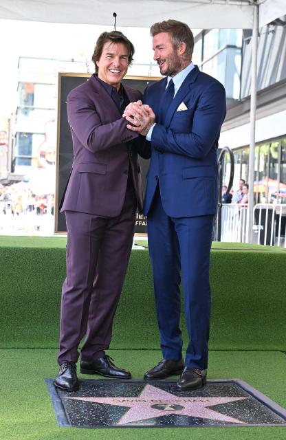 English former footballer David Beckham and US actor Tom Cruise pose next to Beckham's newly unveiled Hollywood Walk of Fame star during a ceremony in Hollywood, California, on June 12, 2026. (Photo by LISA O'CONNOR / AFP)