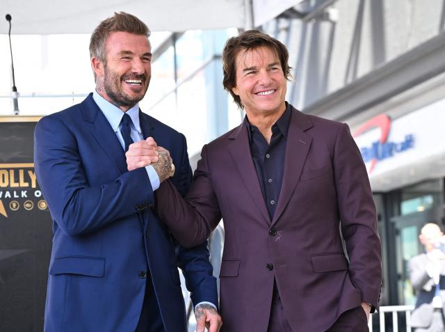 English former footballer David Beckham and US actor Tom Cruise pose next to Beckham's newly unveiled Hollywood Walk of Fame star during a ceremony in Hollywood, California, on June 12, 2026. (Photo by LISA O'CONNOR / AFP)