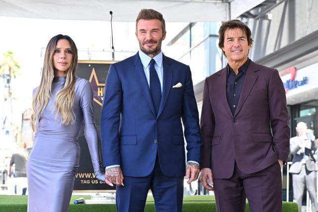 Victoria Beckham, English former footballer David Beckham and US actor Tom Cruise pose next to Beckham's newly unveiled Hollywood Walk of Fame star during a ceremony in Hollywood, California, on June 12, 2026. (Photo by LISA O'CONNOR / AFP)