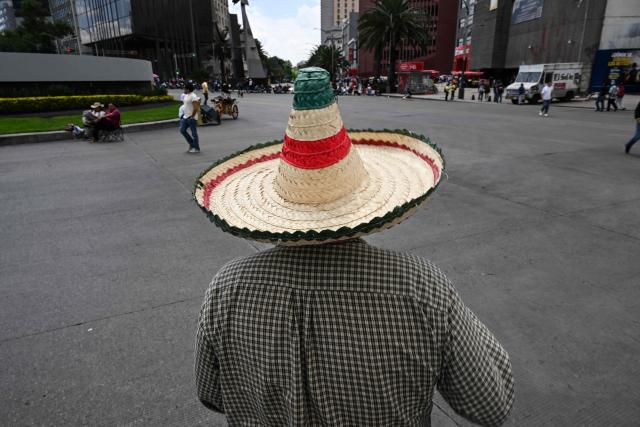 A teacher and member of the National Coordinator of Education Workers (CNTE) wears a traditional Mexican hat while participating in a day of protest demanding better employment benefits in Mexico City on June 12, 2026. Teachers, along with students from the Ayotzinapa co-ed rural school and groups searching for missing persons, have been staging ongoing protests since last week against the FIFA World Cup. (Photo by Yuri CORTEZ / AFP)