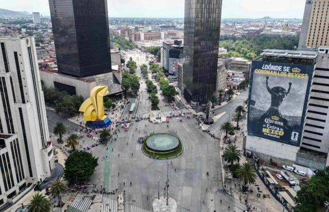 In this aerial view teachers from the National Coordinator of Education Workers (CNTE) remain at a barricade blocking major avenues during a day of protest demanding better employment benefits in Mexico City on June 12, 2026. Teachers, along with students from the Ayotzinapa co-ed rural school and groups searching for missing persons, have been staging ongoing protests against the FIFA 2026 World Cup. (Photo by Yuri CORTEZ / AFP)