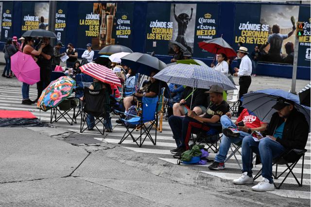Teachers from the National Coordinator of Education Workers (CNTE) sit at a barricade blocking major avenues during a day of protest demanding better employment benefits in Mexico City on June 12, 2026. Teachers, along with students from the Ayotzinapa co-ed rural school and groups searching for missing persons, have been staging ongoing protests against the FIFA 2026 World Cup. (Photo by Yuri CORTEZ / AFP)
