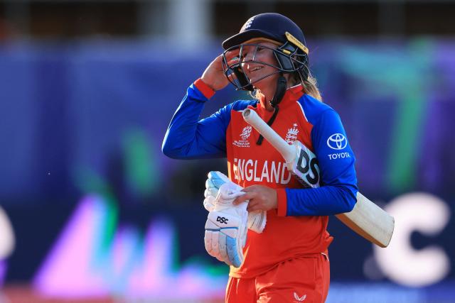 England's Danni Wyatt-Hodge (R) celebrates after England's innings the first day of the ICC Women's T20 cricket World Cup 2026 Group 2 stage cricket match between England and Sri Lanka at Edgbaston cricket ground in Birmingham, central England on June 12, 2026. (Photo by Darren Staples / AFP)
