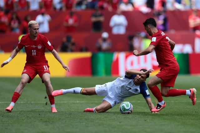 Bosnia-Herzegovina's defender #07 Amar Dedic (C) fights for the ball with Canada's midfielder #11 Liam Millar (L) and Canada's midfielder #07 Stephen Eustaquio during the 2026 World Cup Group B football match between Canada and Bosnia and Herzegovina at the Toronto Stadium in Toronto on June 12, 2026. (Photo by Cole Burston / AFP)