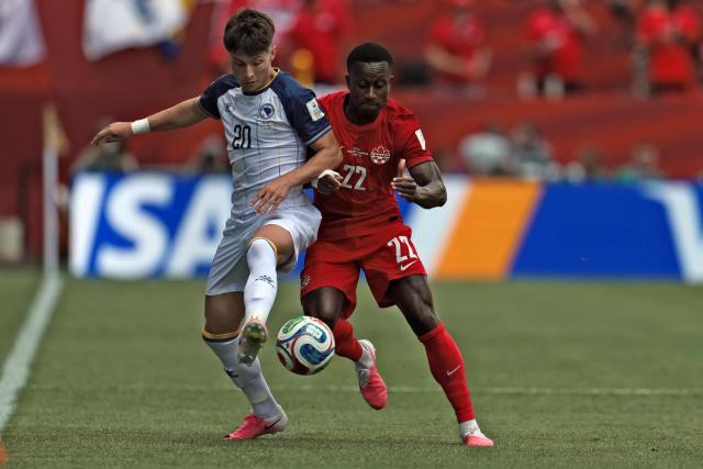 Bosnia-Herzegovina's forward #20 Esmir Bajraktarevic (L) fights for the ball with Canada's defender #22 Richie Laryea during the 2026 World Cup Group B football match between Canada and Bosnia and Herzegovina at the Toronto Stadium in Toronto on June 12, 2026. (Photo by Cole Burston / AFP)