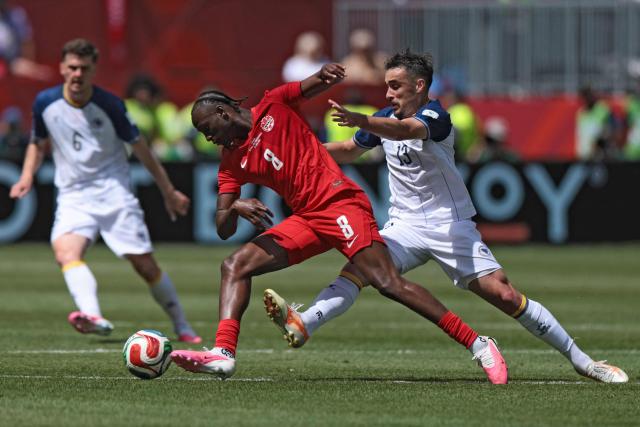 Canada's midfielder #08 Ismael Kone (C) fights for the ball with Bosnia-Herzegovina's midfielder #13 Ivan Basic during the 2026 World Cup Group B football match between Canada and Bosnia and Herzegovina at the Toronto Stadium in Toronto on June 12, 2026. (Photo by Cole Burston / AFP)