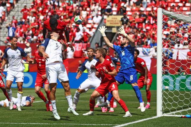 Canada's forward #12 Tani Oluwaseyi (up) fights for the ball with Bosnia-Herzegovina's defender #05 Sead Kolasinac during the 2026 World Cup Group B football match between Canada and Bosnia and Herzegovina at the Toronto Stadium in Toronto on June 12, 2026. (Photo by Cole Burston / AFP)