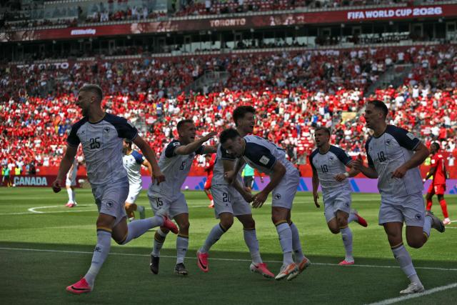Bosnia-Herzegovina's forward #25 Jovo Lukic (L) celebrates after scoring a goal during the 2026 World Cup Group B football match between Canada and Bosnia and Herzegovina at the Toronto Stadium in Toronto on June 12, 2026. (Photo by Cole Burston / AFP)