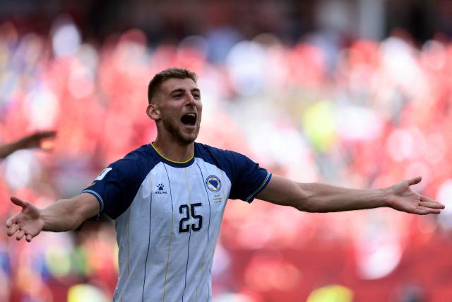 Bosnia-Herzegovina's forward #25 Jovo Lukic (L) celebrates after scoring a goal during the 2026 World Cup Group B football match between Canada and Bosnia and Herzegovina at the Toronto Stadium in Toronto on June 12, 2026. (Photo by Cole Burston / AFP)