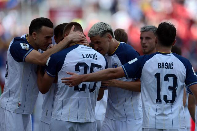 Bosnia-Herzegovina's forward #25 Jovo Lukic (C) is congratulated by teammates after scoring a goal celebrates after scoring a goal during the 2026 World Cup Group B football match between Canada and Bosnia and Herzegovina at the Toronto Stadium in Toronto on June 12, 2026. (Photo by Cole Burston / AFP)