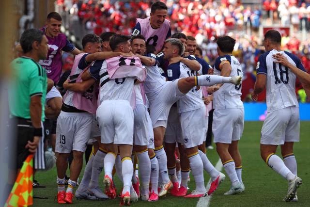 Bosnia-Herzegovina's forward #25 Jovo Lukic (hiddden) is is congratulated by teammates after scoring a goal during the 2026 World Cup Group B football match between Canada and Bosnia and Herzegovina at the Toronto Stadium in Toronto on June 12, 2026. (Photo by Cole Burston / AFP)