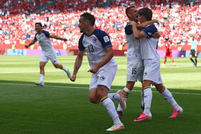 Bosnia-Herzegovina's players celebrate the opening goal during the 2026 World Cup Group B football match between Canada and Bosnia and Herzegovina at the Toronto Stadium in Toronto on June 12, 2026. (Photo by Cole Burston / AFP)