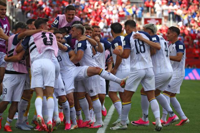 Bosnia-Herzegovina's players celebrate the opening goal during the 2026 World Cup Group B football match between Canada and Bosnia and Herzegovina at the Toronto Stadium in Toronto on June 12, 2026. (Photo by Cole Burston / AFP)