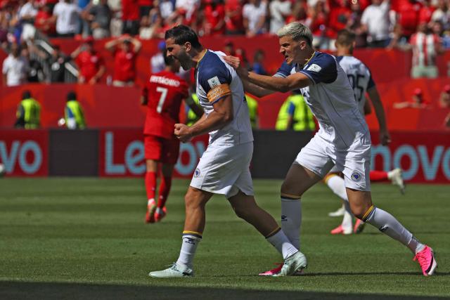 Bosnia-Herzegovina's defender #05 Sead Kolasinac (L) celebrates after clearing the ball off the goal line during the 2026 World Cup Group B football match between Canada and Bosnia and Herzegovina at the Toronto Stadium in Toronto on June 12, 2026. (Photo by Cole Burston / AFP)