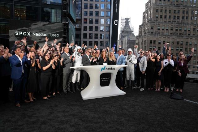SpaceX employees cheer after the closing bell at the Nasdaq MarketSite following the launch of SpaceX’s initial public offering (IPO) in New York on June 12, 2026. Shares in Elon Musk's SpaceX closed almost 20 percent higher on their trading debut Friday after the biggest IPO in history, making the polarizing entrepreneur the world's first trillionaire as he vowed to take humanity to Mars. (Photo by TIMOTHY A. CLARY / AFP)