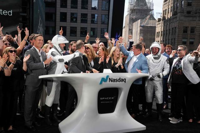 SpaceX employees cheer after the closing bell at the Nasdaq MarketSite following the launch of SpaceX’s initial public offering (IPO) in New York on June 12, 2026. Shares in Elon Musk's SpaceX closed almost 20 percent higher on their trading debut Friday after the biggest IPO in history, making the polarizing entrepreneur the world's first trillionaire as he vowed to take humanity to Mars. (Photo by TIMOTHY A. CLARY / AFP)