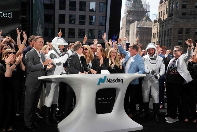 SpaceX employees cheer after the closing bell at the Nasdaq MarketSite following the launch of SpaceX’s initial public offering (IPO) in New York on June 12, 2026. Shares in Elon Musk's SpaceX closed almost 20 percent higher on their trading debut Friday after the biggest IPO in history, making the polarizing entrepreneur the world's first trillionaire as he vowed to take humanity to Mars. (Photo by TIMOTHY A. CLARY / AFP)