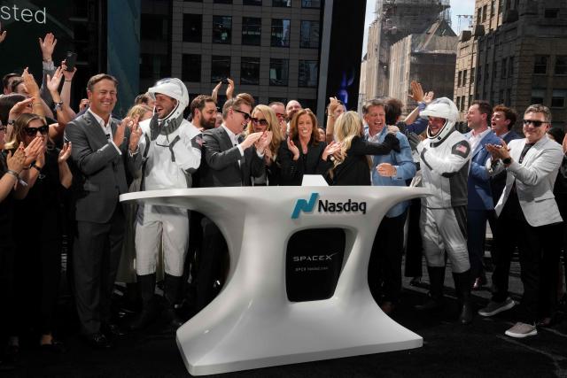 SpaceX employees cheer after the closing bell at the Nasdaq MarketSite following the launch of SpaceX’s initial public offering (IPO) in New York on June 12, 2026. Shares in Elon Musk's SpaceX closed almost 20 percent higher on their trading debut Friday after the biggest IPO in history, making the polarizing entrepreneur the world's first trillionaire as he vowed to take humanity to Mars. (Photo by TIMOTHY A. CLARY / AFP)
