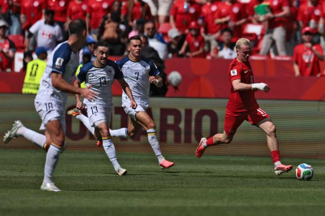 Canada's midfielder #11 Liam Millar (R) runs with the ball followed by Bosnia-Herzegovina's defender #18 Nikola Katic (L), Bosnia-Herzegovina's midfielder #13 Ivan Basic (2ndL) and Bosnia-Herzegovina's defender #07 Amar Dedic (C) during the 2026 World Cup Group B football match between Canada and Bosnia and Herzegovina at the Toronto Stadium in Toronto on June 12, 2026. (Photo by Cole Burston / AFP)