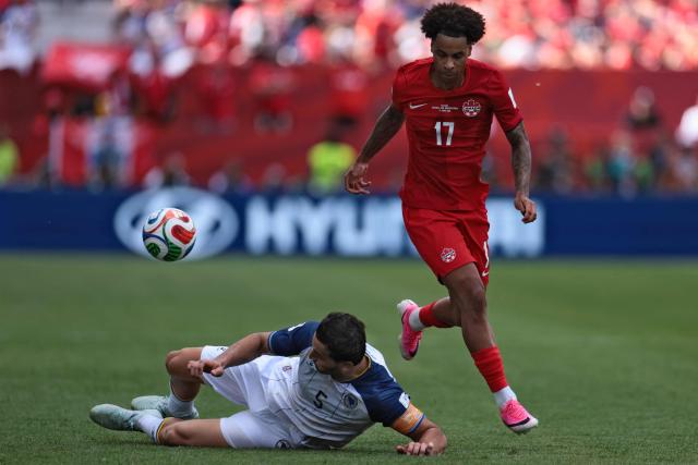 Canada's midfielder #17 Tajon Buchanan (R) is tackled by Bosnia-Herzegovina's defender #05 Sead Kolasinac during the 2026 World Cup Group B football match between Canada and Bosnia and Herzegovina at the Toronto Stadium in Toronto on June 12, 2026. (Photo by Cole Burston / AFP)
